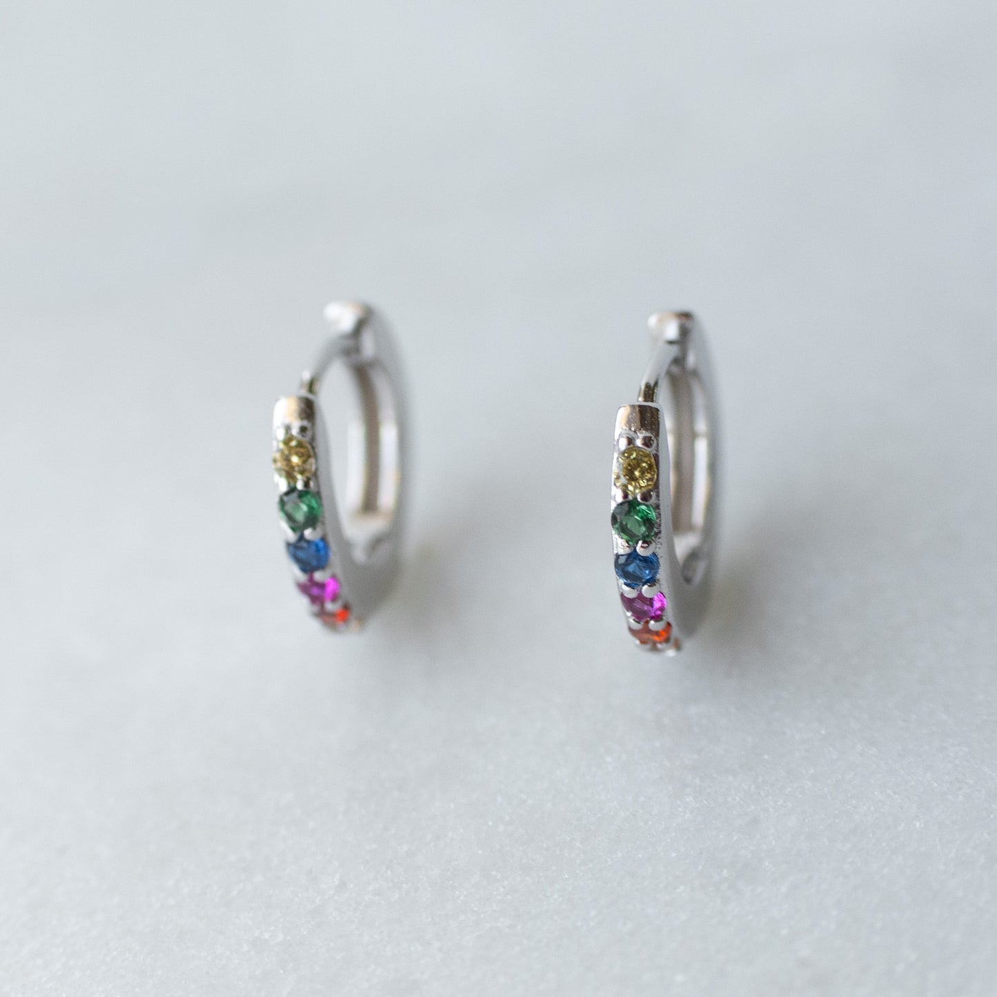 Rainbow huggie hoops in silver