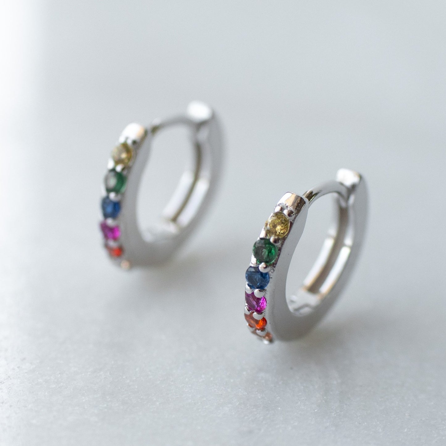 Rainbow huggie hoops in silver