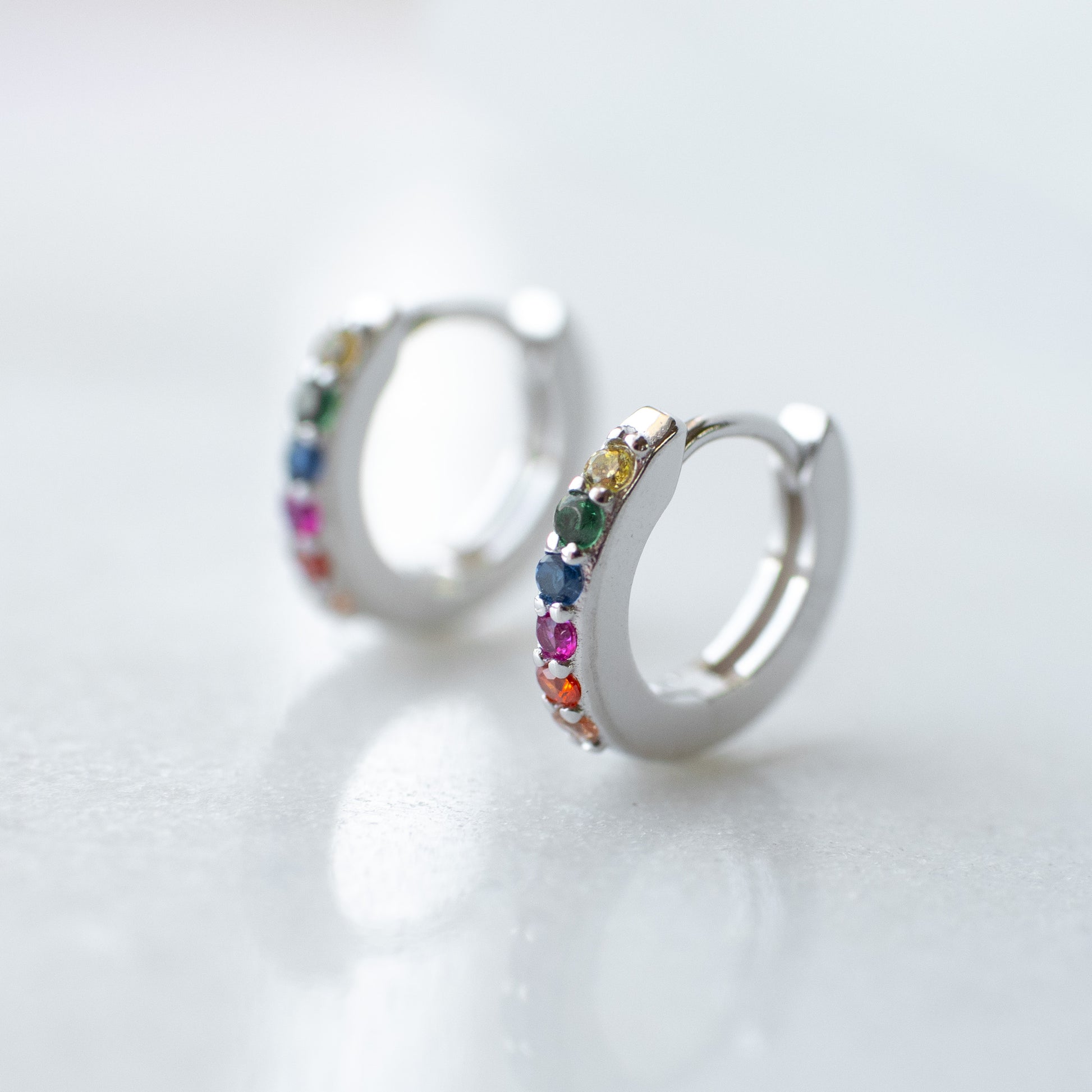 Rainbow huggie hoops in silver